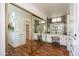 Spacious bathroom featuring large, mirrored closet doors and a vanity area at 632 S 83Rd Way, Mesa, AZ 85208