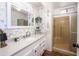 Bathroom with decorative mirror, decorative wall trim, and convenient walk-in shower at 632 S 83Rd Way, Mesa, AZ 85208