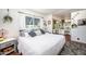 Comfortable bedroom with a white bedspread and a vanity in an attached room at 632 S 83Rd Way, Mesa, AZ 85208