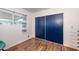 Well-lit bedroom features wood floors and large closet with paneled doors at 632 S 83Rd Way, Mesa, AZ 85208
