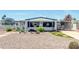 Charming single-story home featuring a rock yard, covered parking, and mature trees at 632 S 83Rd Way, Mesa, AZ 85208
