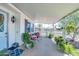Inviting covered front porch with ample seating area and lush greenery at 632 S 83Rd Way, Mesa, AZ 85208