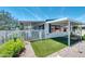 Charming home exterior showcasing a well-manicured front yard with artificial turf, gravel, and a white picket fence at 632 S 83Rd Way, Mesa, AZ 85208