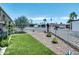 Landscaped front yard with gravel, artificial turf, white picket fence, and various desert plants on a sunny day at 632 S 83Rd Way, Mesa, AZ 85208