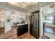 Bright kitchen with stainless steel refrigerator, black cabinets, and easy access to dining area at 632 S 83Rd Way, Mesa, AZ 85208