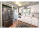 Charming kitchen featuring white cabinets, modern appliances, and hardwood floors at 632 S 83Rd Way, Mesa, AZ 85208