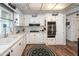 Bright kitchen with white cabinets, stainless steel appliances, and tiled ceiling at 632 S 83Rd Way, Mesa, AZ 85208