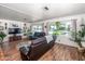 Comfortable living room with a cozy brown leather sofa and bright, sunny windows at 632 S 83Rd Way, Mesa, AZ 85208