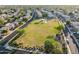 Ariel view showcasing a community park with playground and picnic areas amidst suburban homes and streets at 7463 E Monte Ave, Mesa, AZ 85209