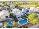 Aerial view of homes with a swimming pool and a community park featuring a playground at 7463 E Monte Ave, Mesa, AZ 85209