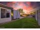 Lush backyard featuring a well-maintained lawn, covered patio, and secure pool fencing at 7463 E Monte Ave, Mesa, AZ 85209