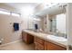 Bright bathroom features double sink, large vanity with cabinets and drawers at 7463 E Monte Ave, Mesa, AZ 85209