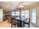 An open kitchen concept with warm wood cabinetry, a central island, and plenty of natural light at 7463 E Monte Ave, Mesa, AZ 85209