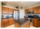Bright kitchen featuring an island with granite countertops and stainless steel appliances at 7463 E Monte Ave, Mesa, AZ 85209