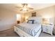 Bright main bedroom features a ceiling fan, ensuite bathroom and comfortable layout at 7463 E Monte Ave, Mesa, AZ 85209