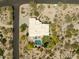 Aerial view of a home with desert landscaping, a sparkling pool, and a private backyard at 8601 E De La O Rd, Scottsdale, AZ 85255