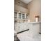 Charming bar area with white cabinets, countertop, sink, and stylish tile flooring at 8601 E De La O Rd, Scottsdale, AZ 85255