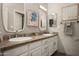 Bathroom with dual sinks, granite countertops, decorative mirrors, and stainless steel hardware at 8601 E De La O Rd, Scottsdale, AZ 85255