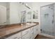 Bathroom with granite counters, a glass shower, and white cabinetry at 8601 E De La O Rd, Scottsdale, AZ 85255