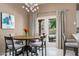 Cozy dining area featuring a table, stylish chairs, and access to the backyard at 8601 E De La O Rd, Scottsdale, AZ 85255