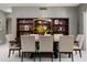 Elegant dining room with stylish furnishings, modern lighting, and custom shelving for sophisticated dining experiences at 8601 E De La O Rd, Scottsdale, AZ 85255