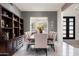 Elegant dining room with stylish furnishings, modern lighting, and custom shelving for sophisticated dining experiences at 8601 E De La O Rd, Scottsdale, AZ 85255