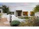 Stunning Santa Fe home with beautiful desert landscaping and a charming front entrance, perfect for luxury living at 8601 E De La O Rd, Scottsdale, AZ 85255