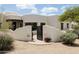 Charming Santa Fe home with an inviting courtyard, beautiful desert landscaping and stylish front gate at 8601 E De La O Rd, Scottsdale, AZ 85255
