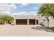 Spacious three-car garage with concrete driveway and a basketball hoop for outdoor fun and games at 8601 E De La O Rd, Scottsdale, AZ 85255