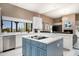 Bright kitchen with a large island, stainless steel appliances, and view to the living area at 8601 E De La O Rd, Scottsdale, AZ 85255