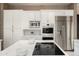 Modern kitchen showcasing white cabinets, stainless steel appliances, and a center island with cooktop at 8601 E De La O Rd, Scottsdale, AZ 85255