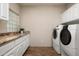 Laundry room with granite countertops and front loading washer and dryer at 8601 E De La O Rd, Scottsdale, AZ 85255