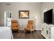 Sitting area with comfortable leather chairs and a TV, located in the main bedroom at 8601 E De La O Rd, Scottsdale, AZ 85255