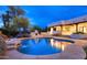 Backyard pool area with a water feature, outdoor fireplace, and landscaped surroundings at 8601 E De La O Rd, Scottsdale, AZ 85255