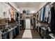 Spacious walk-in closet with built-in shelving, drawers, and ample storage for clothing at 8601 E De La O Rd, Scottsdale, AZ 85255