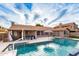 Gorgeous pool and patio area features a basketball hoop, outdoor kitchen, and an umbrella-covered lounge area at 8875 S Ash Ave, Tempe, AZ 85284