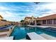 Backyard with sparkling pool, a water feature, and a covered patio with an outdoor seating area at 8875 S Ash Ave, Tempe, AZ 85284