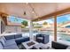 An inviting backyard with a pool and an outdoor seating area featuring a fire pit and an umbrella at 8875 S Ash Ave, Tempe, AZ 85284