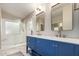 Bathroom featuring double sinks, shaker cabinets and a stand-alone shower at 8875 S Ash Ave, Tempe, AZ 85284