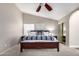 A well-lit bedroom with a king bed, ceiling fan and ensuite bath at 8875 S Ash Ave, Tempe, AZ 85284