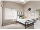Cozy bedroom featuring a metal bed frame, neutral walls, and light-filled window at 8875 S Ash Ave, Tempe, AZ 85284