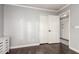 The bedroom boasts hardwood floors, neutral walls, and closet with double doors at 8875 S Ash Ave, Tempe, AZ 85284