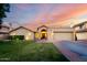 Charming single-story home featuring a well-manicured lawn, arched entryway, and attached two-car garage at 8875 S Ash Ave, Tempe, AZ 85284