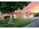 Charming single-story home featuring a well-manicured lawn, arched entryway, and attached two-car garage at 8875 S Ash Ave, Tempe, AZ 85284