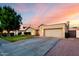 Charming single-story home featuring a well-manicured lawn, arched entryway, and attached two-car garage at 8875 S Ash Ave, Tempe, AZ 85284
