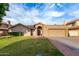 Charming single-story home featuring a well-manicured lawn, arched entryway, and attached two-car garage at 8875 S Ash Ave, Tempe, AZ 85284