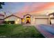 Charming single-Gathering home boasts well-manicured lawn, archway entrance, and attached two car garage at 8875 S Ash Ave, Tempe, AZ 85284