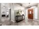 Bright foyer features tiled floors, accent table, and decorative mirror in a neutral color palette at 8875 S Ash Ave, Tempe, AZ 85284