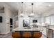 Contemporary kitchen features white cabinets, stainless steel appliances, and a large central island at 8875 S Ash Ave, Tempe, AZ 85284