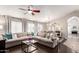 Bright living room featuring hardwood floors, a large sofa, and natural light from large windows at 8875 S Ash Ave, Tempe, AZ 85284